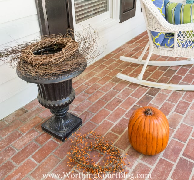 Layering the grapevine wreath onto the urn.