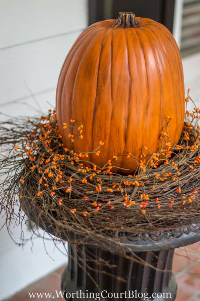 Wrapping the pip berry around the wreath with the pumpkin on top.