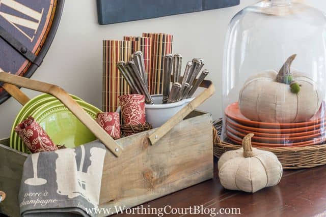 White fabric pumpkin in front of the wooden picnic basket.