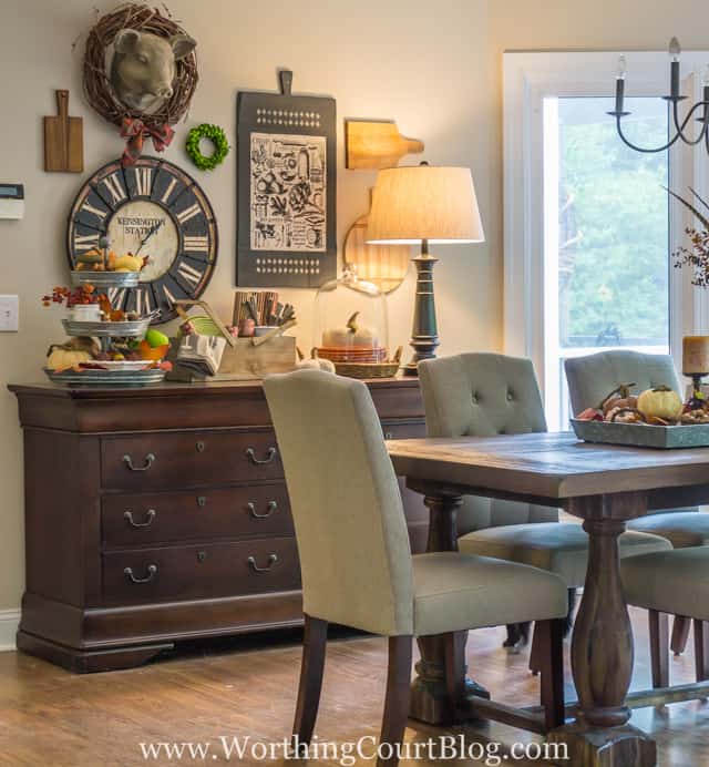 The small lamp is on bringing light to the sideboard and the dining room.