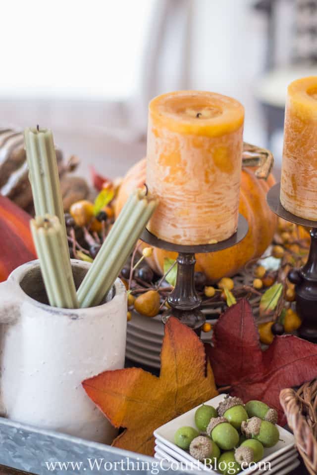 Amber colored candles sitting on a candle stand.