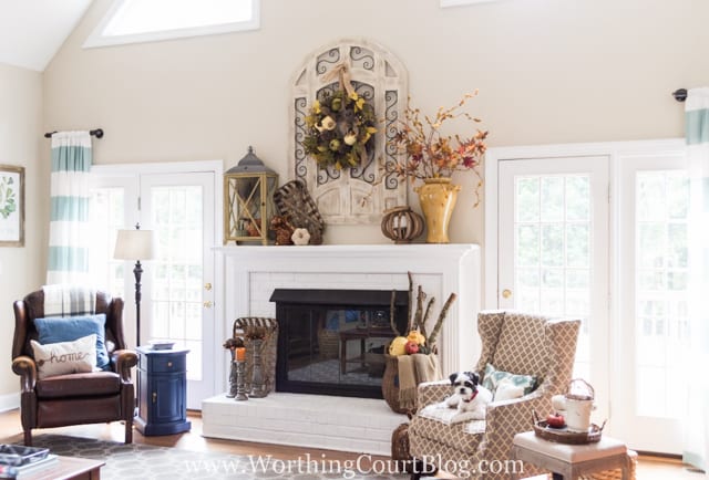 A fireplace flanked by two armchairs in the living room.