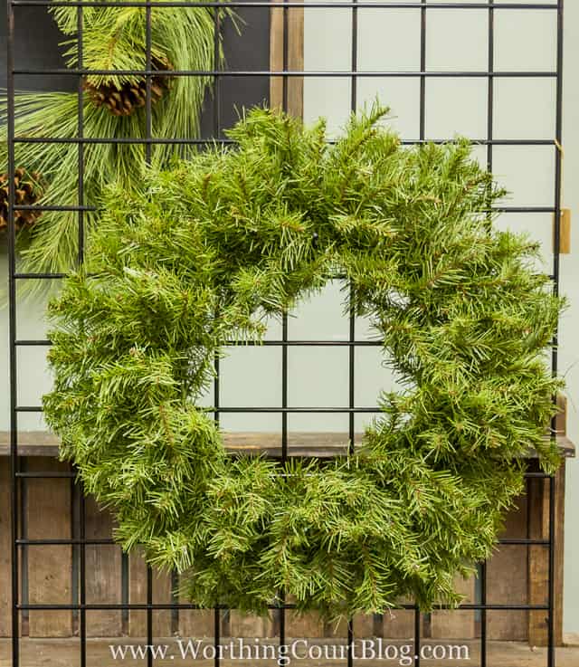 A large green wreath before being decorated.