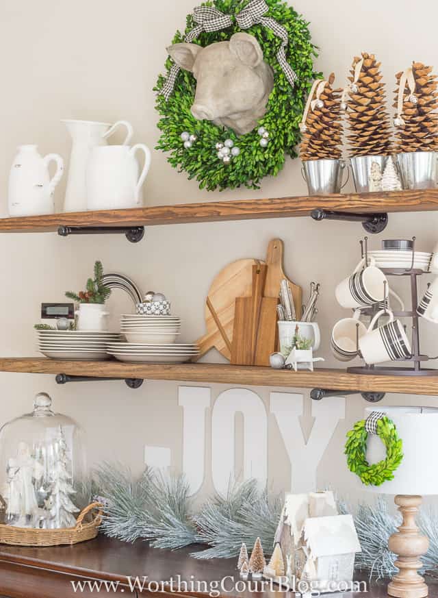 A white Joy sign is on the wall below the last open shelf.