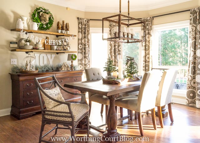 Rustic shelves are above the wooden console table in the dining room.