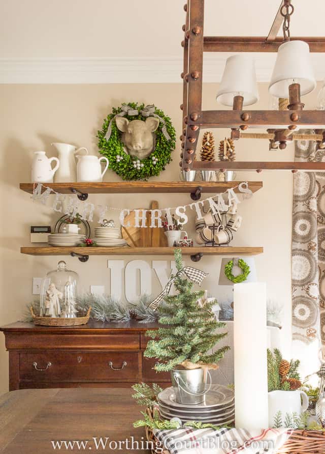 Rustic shelves in the dining room are decorated for Christmas.