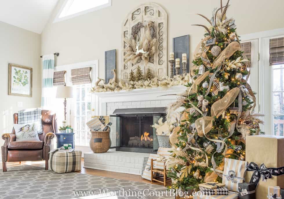 Rustic And Glam Christmas Tree And Mantel with a fire in the fireplace.