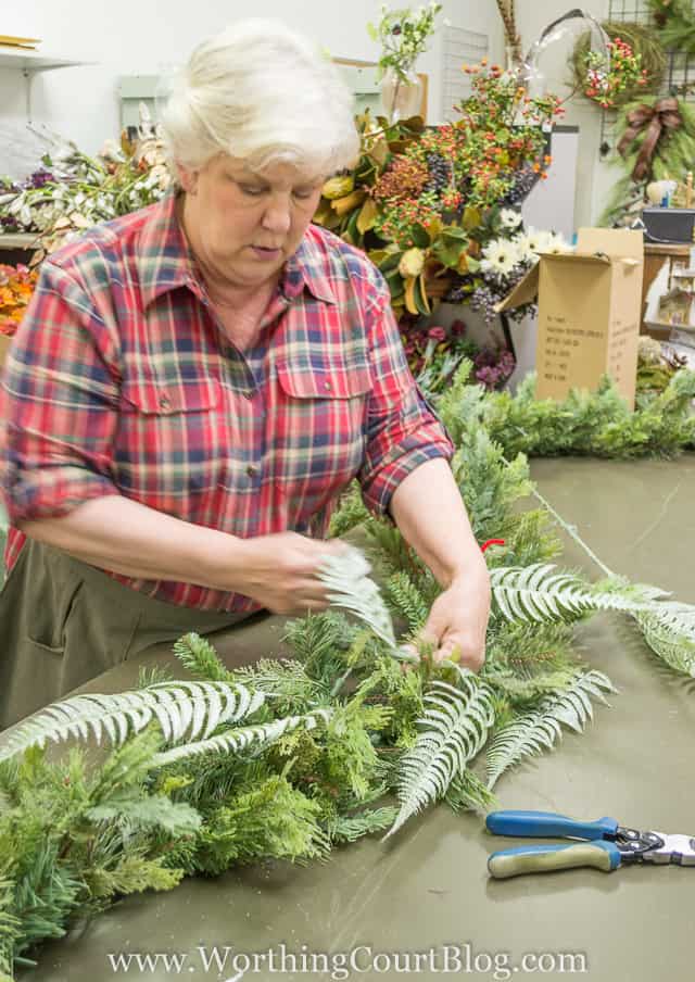 Fluffing the greens and arranging it on a table.