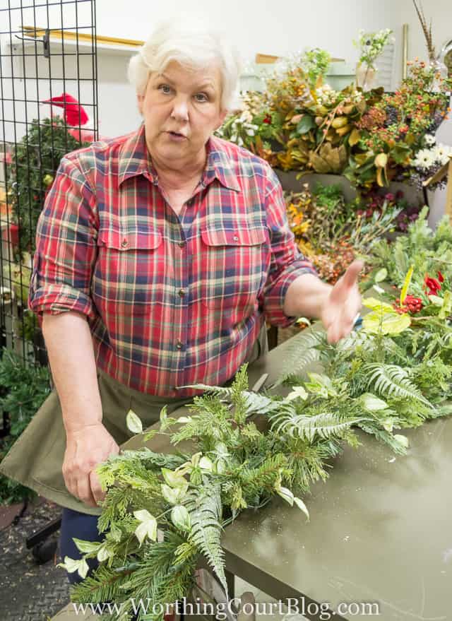 Adding a variety of branches to create texture in the garland.