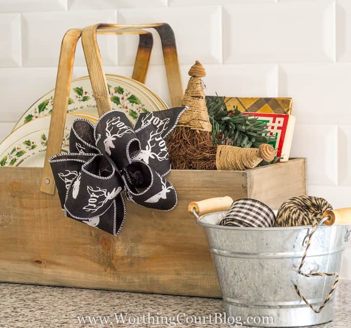 Farmhouse Christmas Kitchen with a wooden box filled with plates and a deer bow.