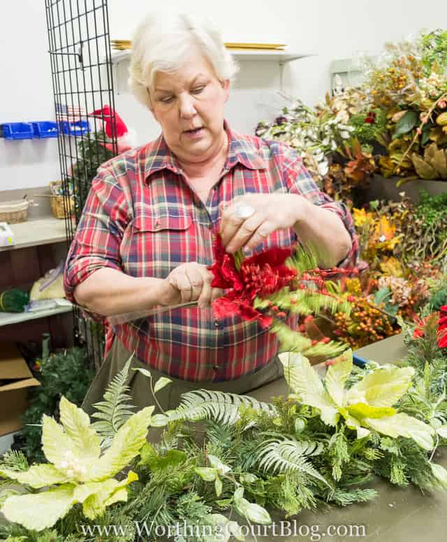 Adding some red berries to the garland.