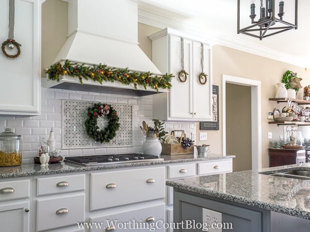 There is a garland on the range hood of the stove.