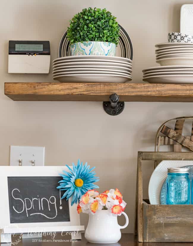 Wooden open shelves with spring decor.