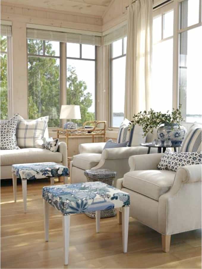 Neutral armchairs wth throw pillows.