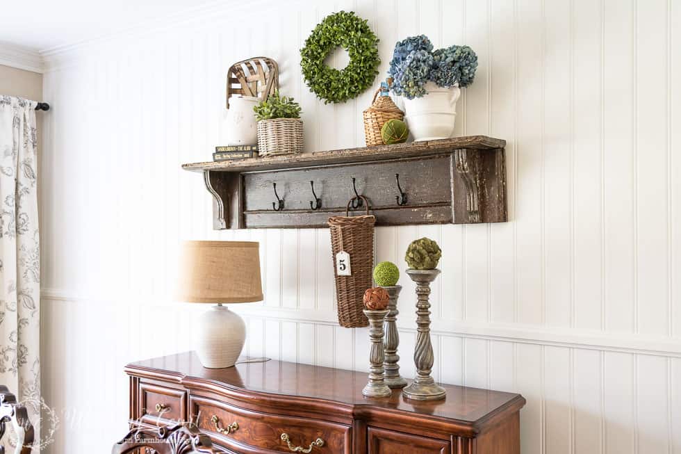 A wooden shelf on the planked wall.