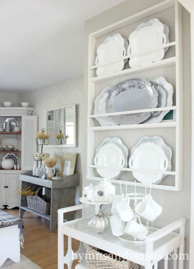 A large plate rack filled with china and stainless steel plates.