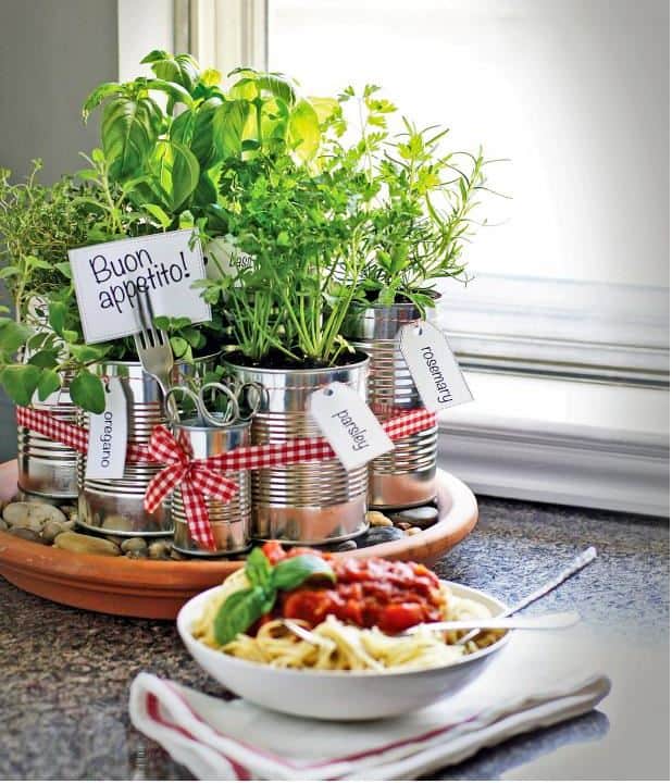 Tin cans with herbs growing in the center of the table.