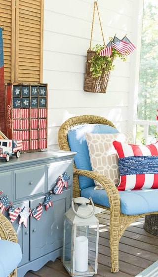 A farmhouse porch filled with loads of red, white and blue vintage Americana patriotic decorating ideas for Memorial Day, Flag Day and July 4th.