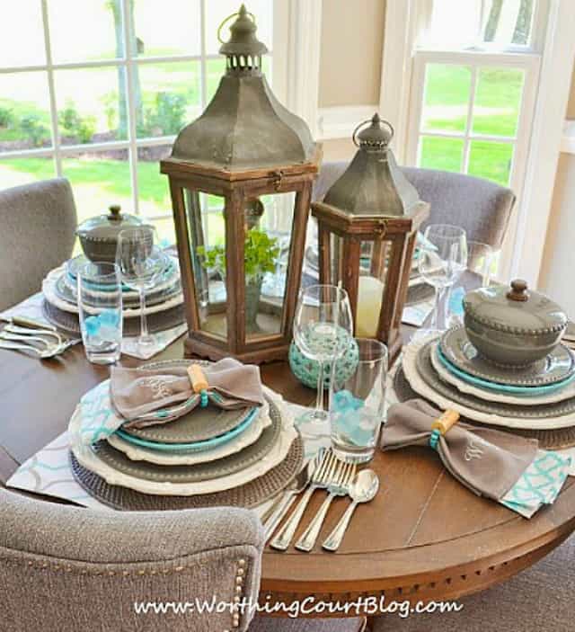 Round table set with gray and blue dishes.