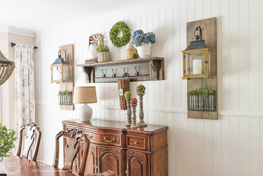 DIY farmhouse style planked shiplap wall with a vintage mantel shelf, buffet and Fixer Upper style wall lanterns.