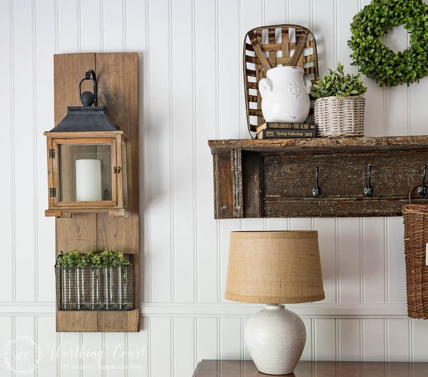 A wooden rustic shelf with coat hangers on it.