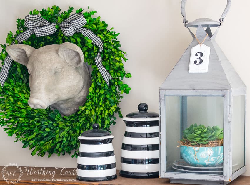 Shelf with lantern and black and white canisters