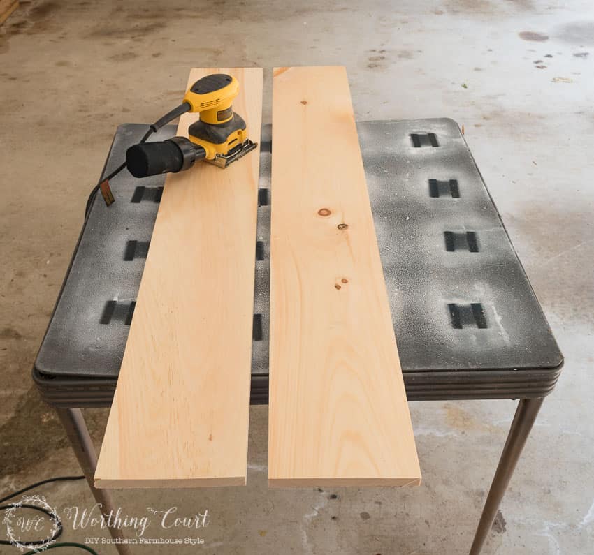 Using a sander on the wooden planks.