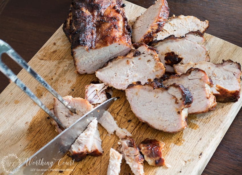 Cutting the pork loin into pieces.