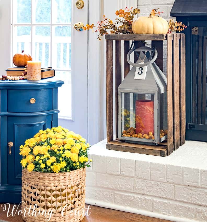 Fall decor on a white brick fireplace hearth