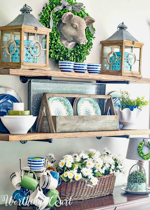 Open shelves decorate with blue, white and green accessories.