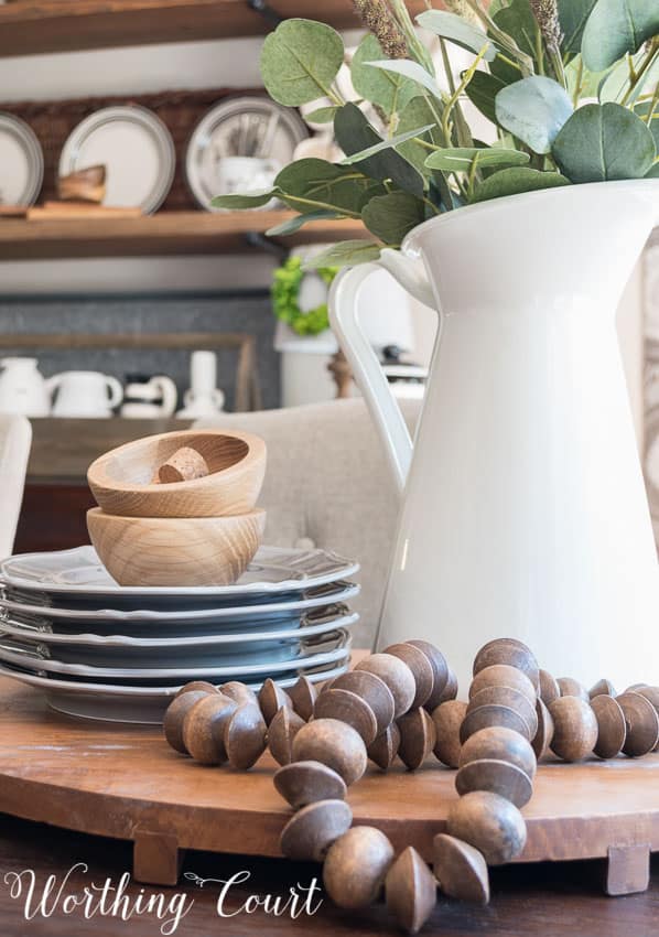 Wooden beads and dishes beside the centerpiece.