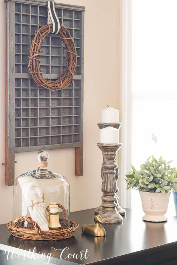 Farmhouse office vignette and printers tray for wall art with a grapevine wreath on it.