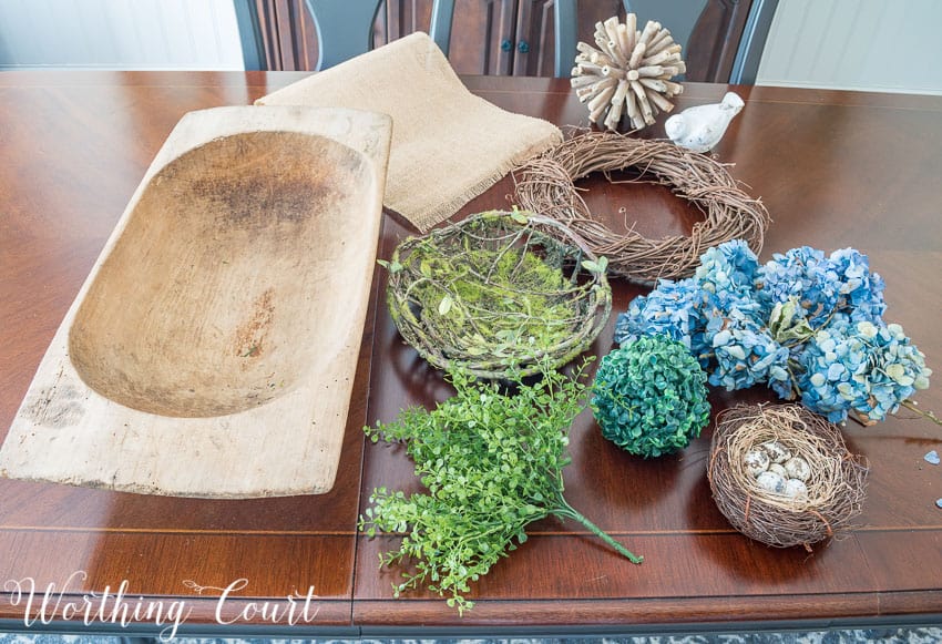 The items for the centerpiece laid out on the table with the dough bowl.