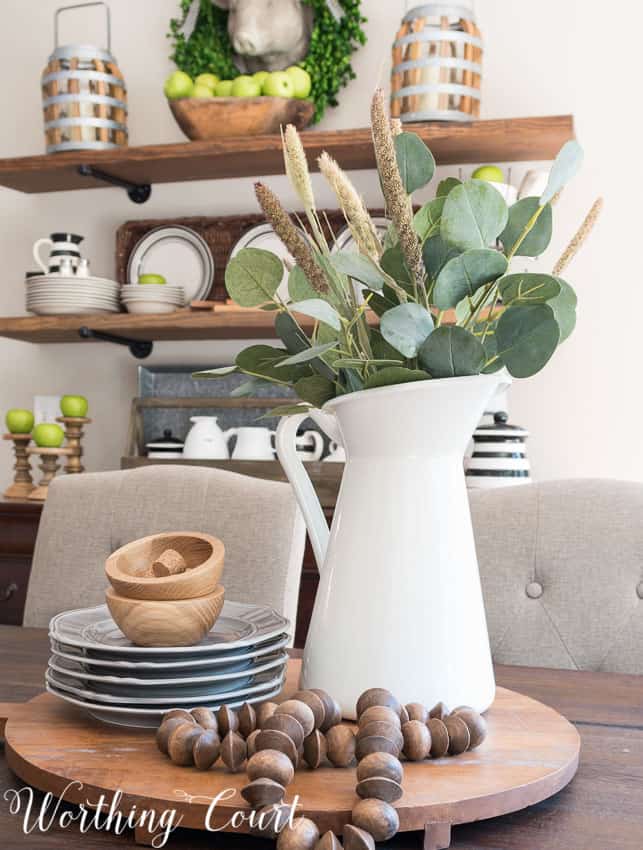 Use a large round wooden cutting board as the base for a centerpiece.