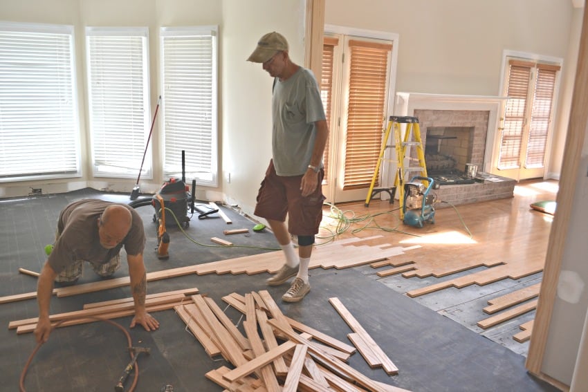 Crew putting in the new flooring in the kitchen.