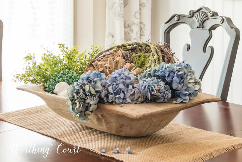 Dough bowl filled with spring decorations.