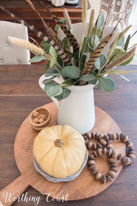 Overhead view of an easy fall centerpiece in the centre of the farmhouse table.