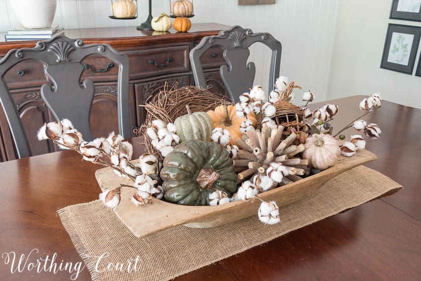 Dough bowl filled with fall goodies, multi colored pumpkins.