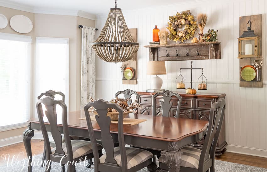 A beaded chandelier is over top the dining room table.