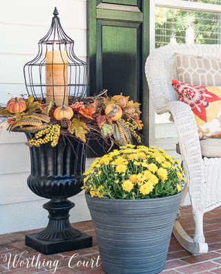 Fall urn with a lantern surrounded by twig wreaths and fall picks || Worthing Court