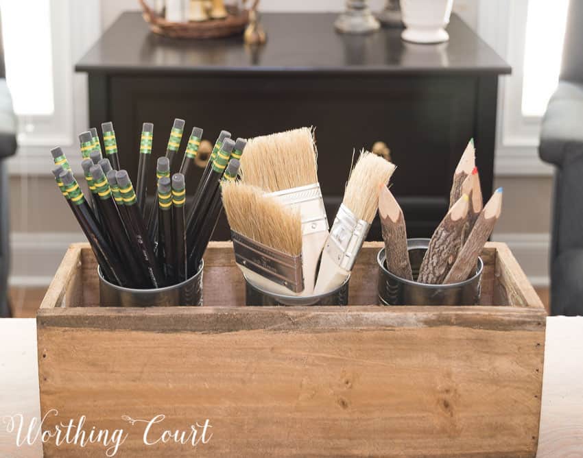 Use a wood box filled with soup cans that have had the labels removed to coral pens and pencils || Worthing Court