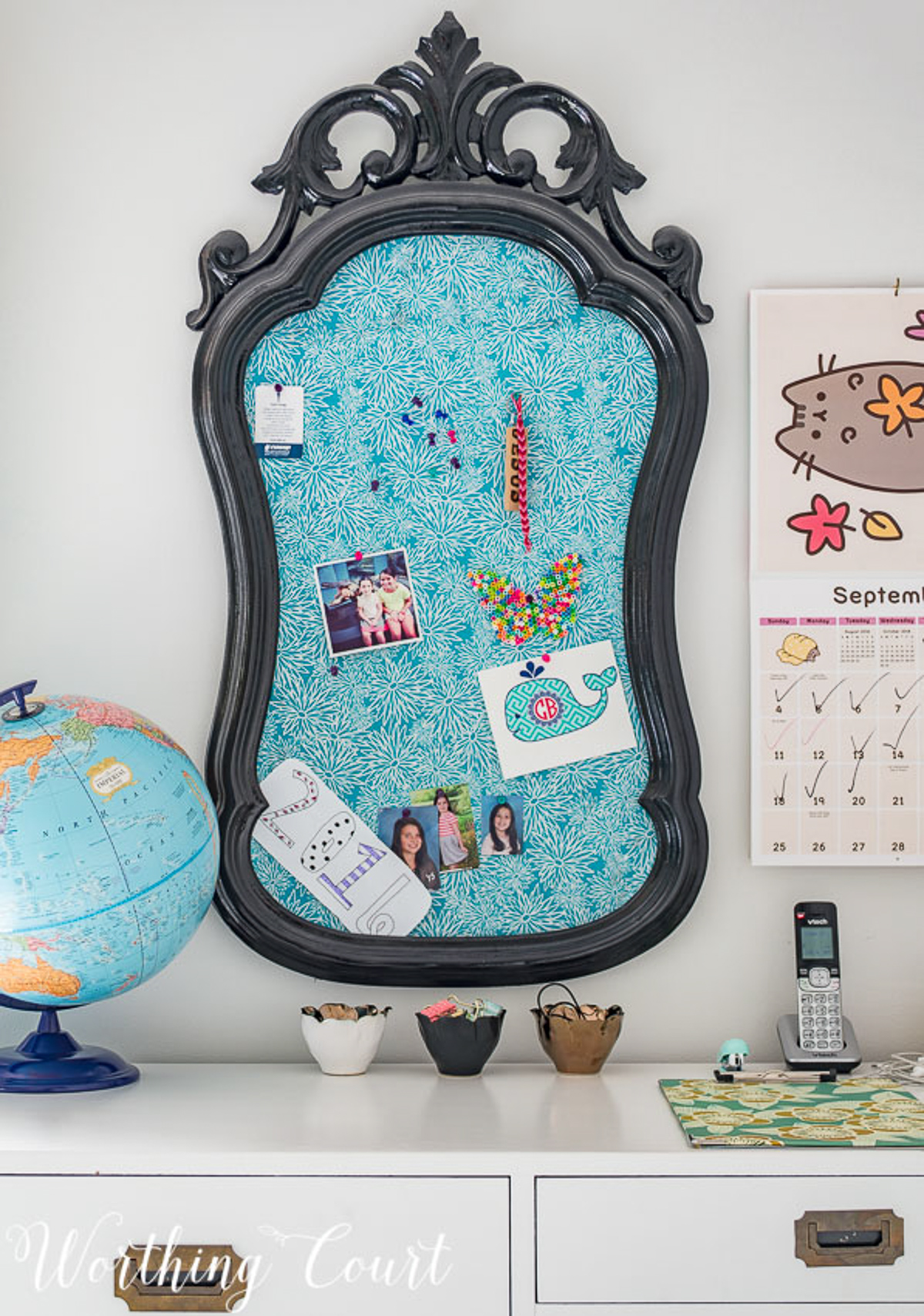 colorful teenage girls bedroom with a pink headboard, furniture painted white, teal lamp shades, teal throw, brass trunk, tissue paper garland and a gallery wall