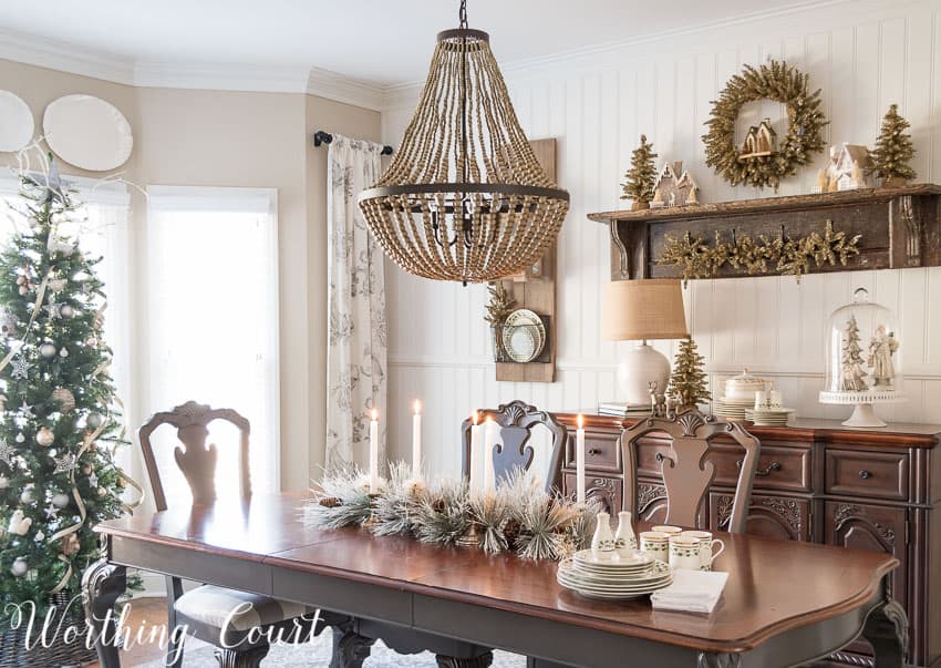 A beaded light fixture hangs above the wooden table.