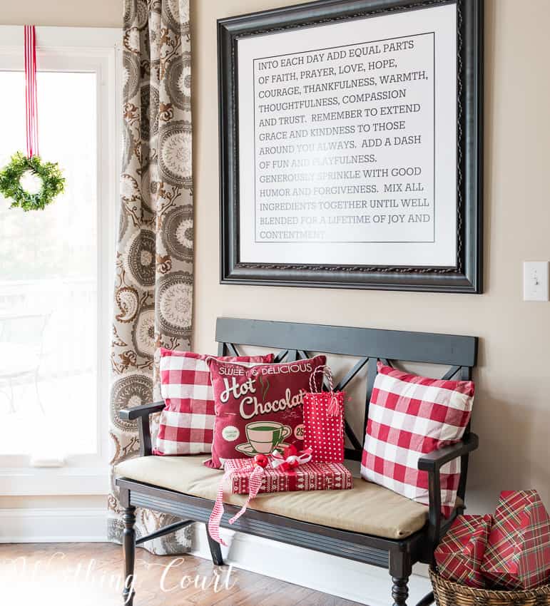 Bench with Christmas pillows on it.