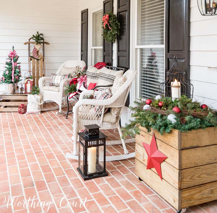 Wicker chairs with plaid pillows.