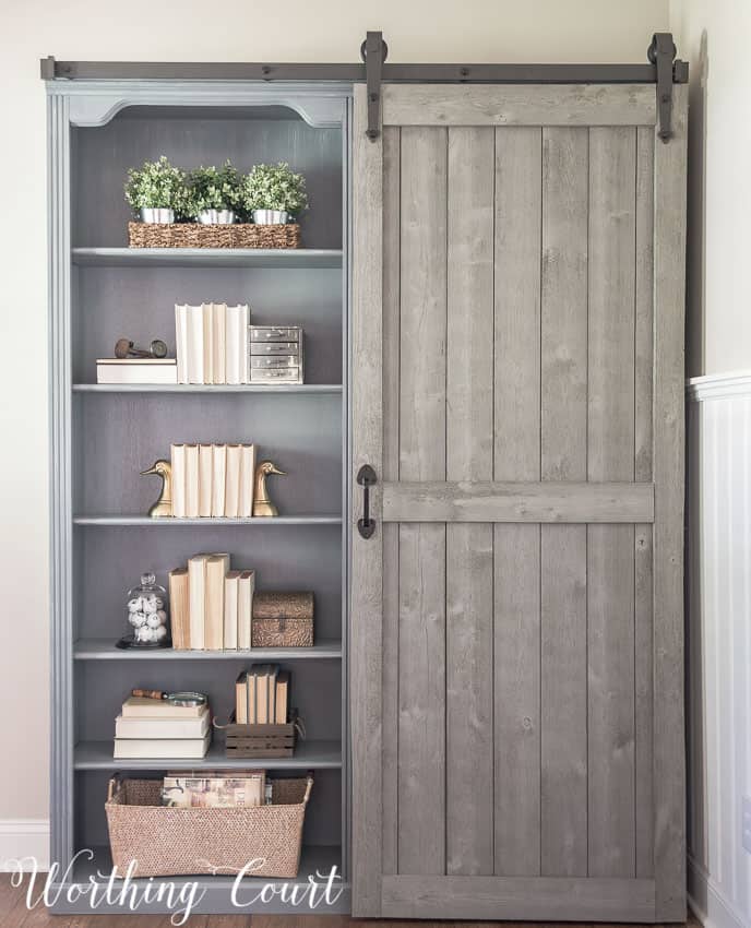 Farmhouse style bookcases with a sliding diy barn door.