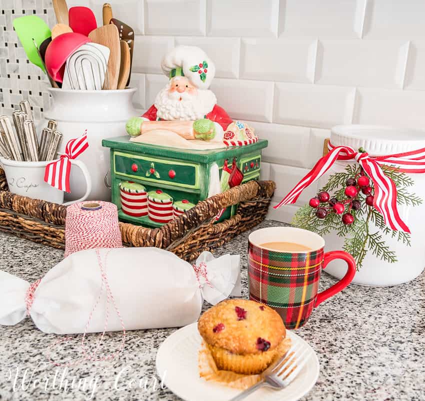 Vintage Fitz and Floyd Christmas cookie jar and a plaid Christmas mug on the kitchen counter.