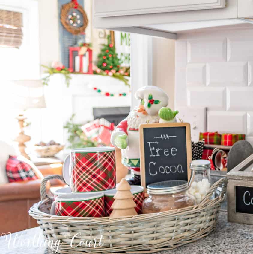 Christmas hot cocoa bar vignette in the kitchen with a little sign saying Free Cocoa.