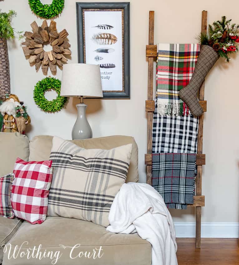 DIY rustic farmhouse ladder with Christmas throws and blankets.