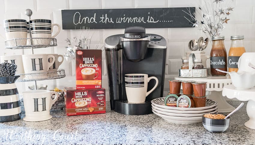 A coffee machine, coffee mugs and coffee on the counter.